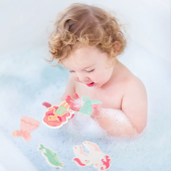 Baby playing with girl/mermaid dress-up bath toy 