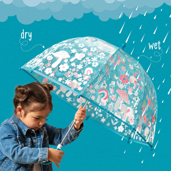 Little girl with the mushroom clear color changing umbrella, showing the dry and wet sides.