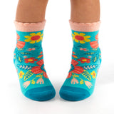Child wearing turquoise floral toddler socks