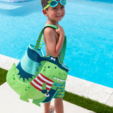 Little boy holding the dino pirate beach tote.