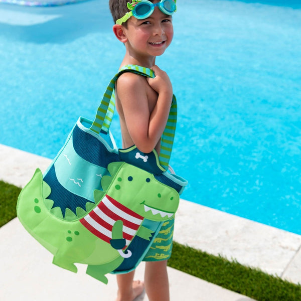 Little boy holding the dino pirate beach tote.