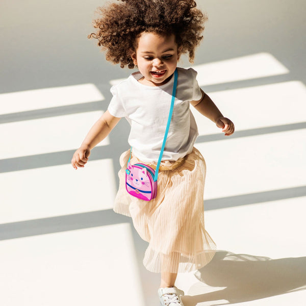 Little girl running with the cat crossbody purse