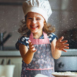 Little girl wearing unicorn holiday apron