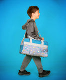 Little boy carrying construction duffle bag