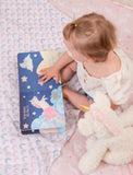 Baby reading the unicorn baby board book.