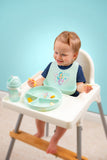 Baby wearing the all over print silicone bib during meal time.