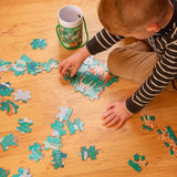 Little boy putting together the animal kingdom educational puzzle.