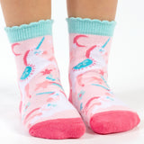 Child wearing rainbow unicorn toddler socks