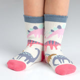 Child wearing pink dino toddler socks