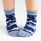 Child wearing navy shark toddler socks