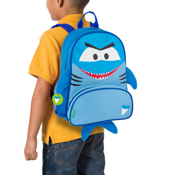 Little boy wearing blue shark sidekick backpack