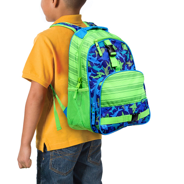 Little boy wearing shark all over print backpack