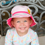 Little girl wearing rainbow bucket hat.