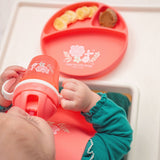 Baby holding coral flower flip top sippy cup