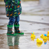 Child wearing multi dino rain gear