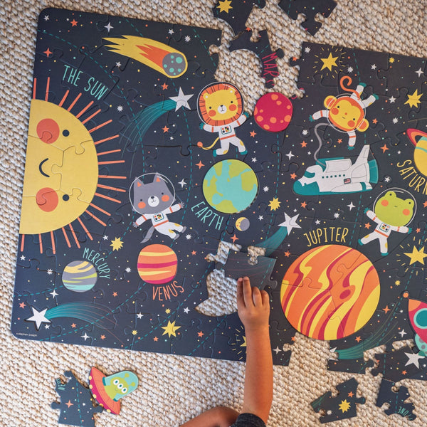 Children putting the space floor puzzle together. 