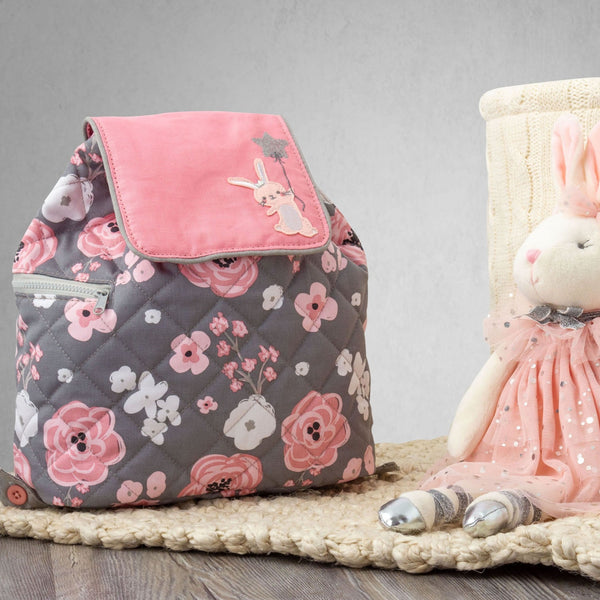 Bunny quilted backpack for baby on a table